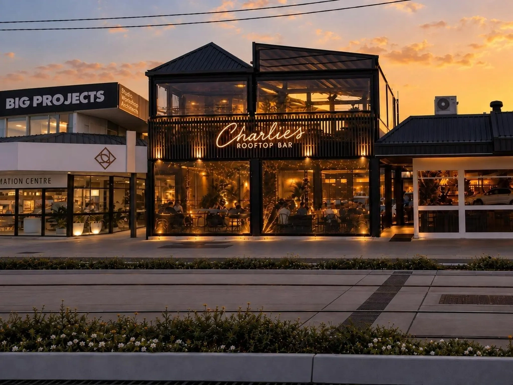 Charlie's Rooftop Bar lit up at sunset on the Gold Coast Highway, Mermaid Beach