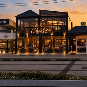 Charlie's Rooftop Bar lit up at sunset on the Gold Coast Highway, Mermaid Beach