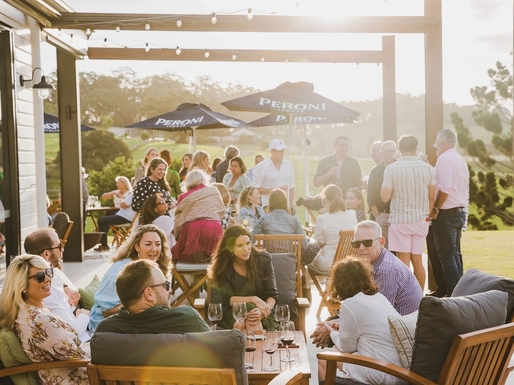 Guests enjoying a drink on The Paddock restaurant's Sunset Terrace