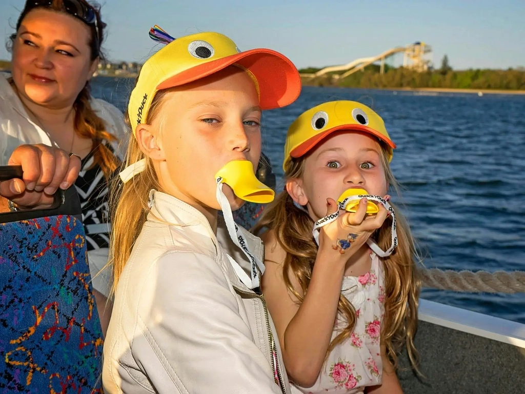 Children on board Quack'R'Duck with merch whistles and visors