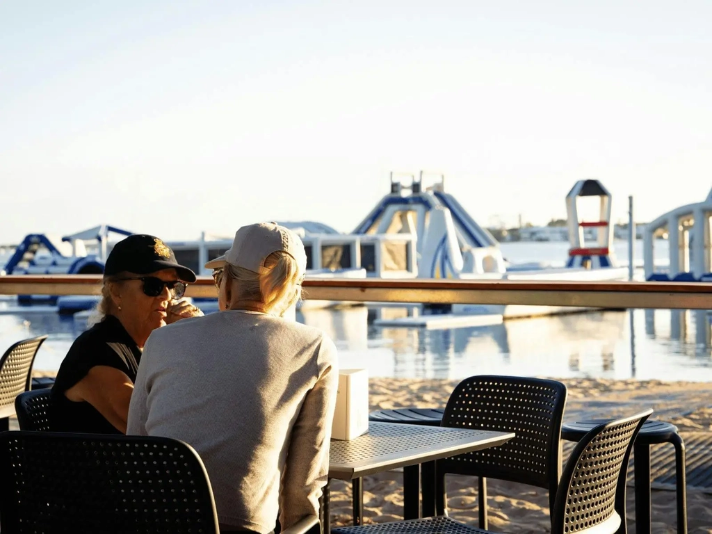 Harley and Hudson Coffee Bar customers overlooking the GC Aqua Park
