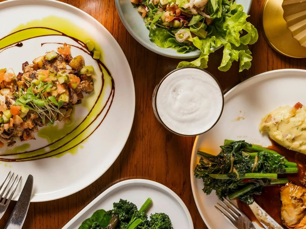 Spread of dishes on table with drinks