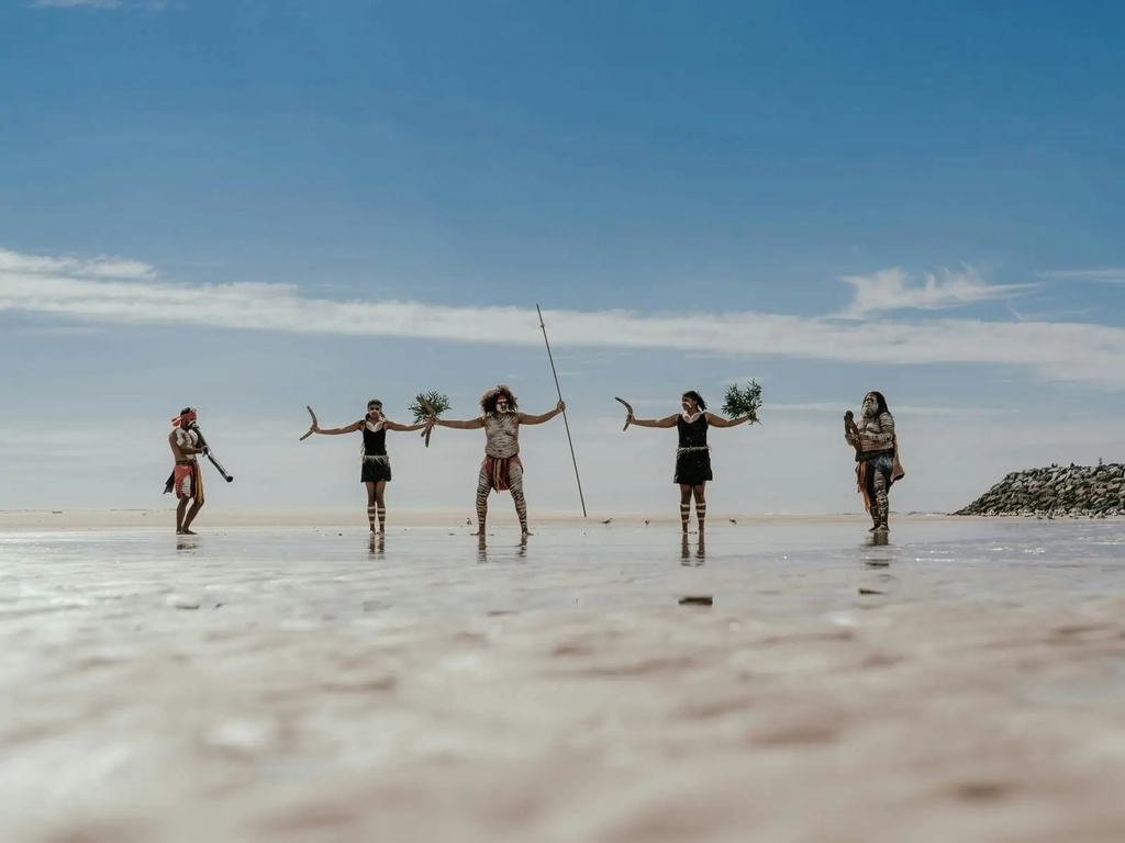 The Yugambeh Aboriginal Dancers perform on the beach during a Jellurgal Walkabout Tour