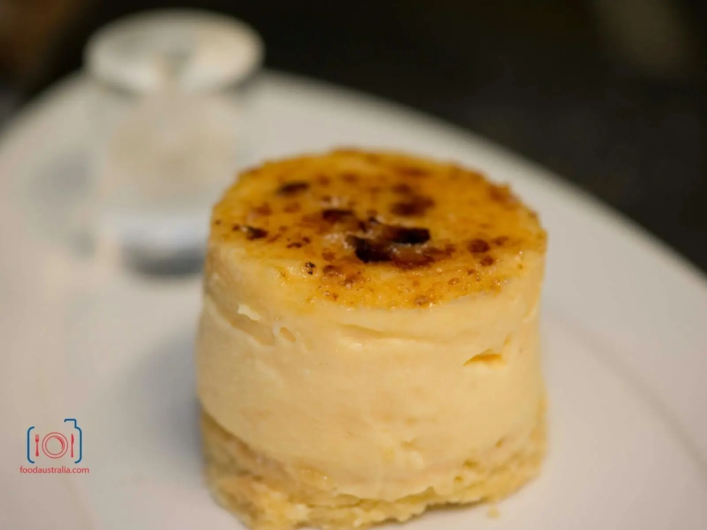 Dessert with charred top on white plate