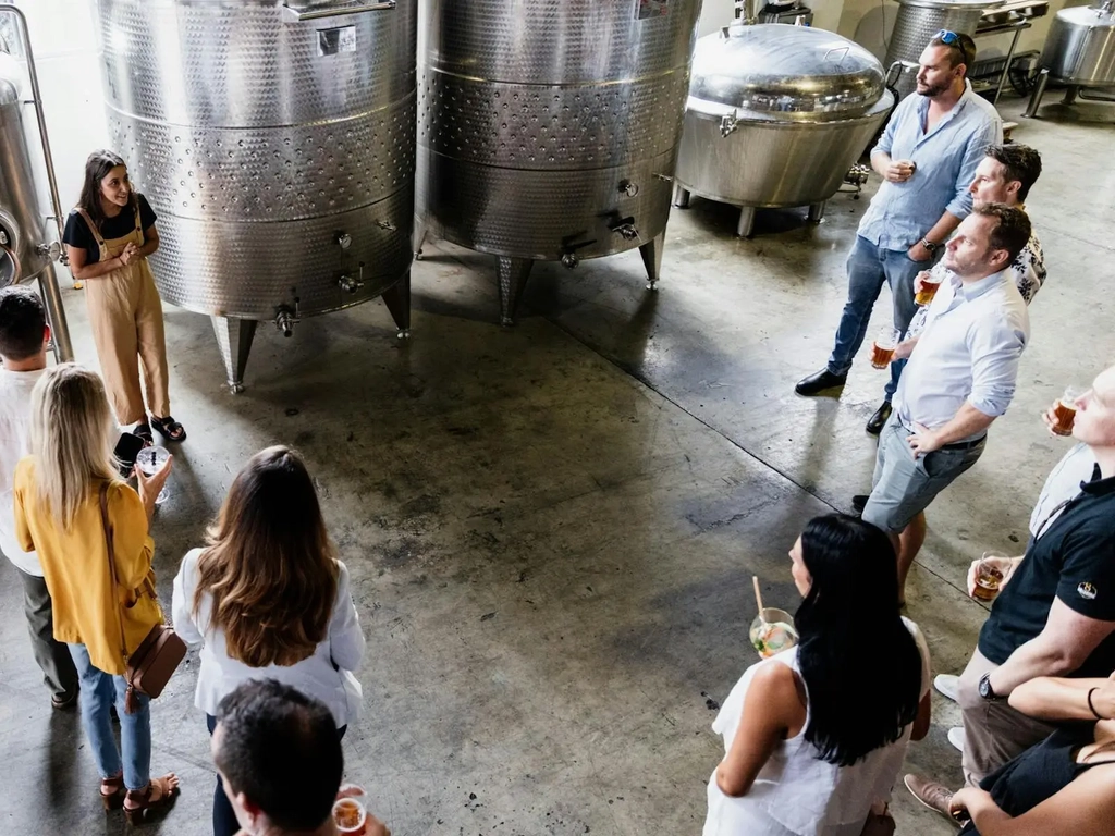 Guests on a tour at Capricorn Distilling Co, learning about distillation.