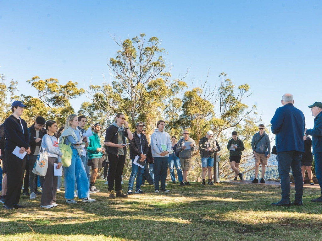 A group enjoying an educational tour activity at Binna Burra