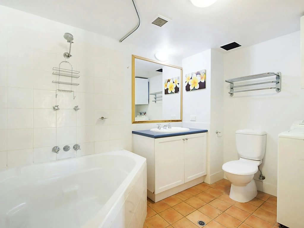 bathroom with shower over large corner bath