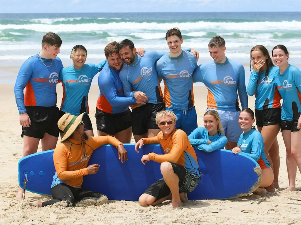 Fun group pic after completing their first surf lesson!