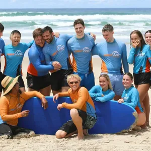 Fun group pic after completing their first surf lesson!