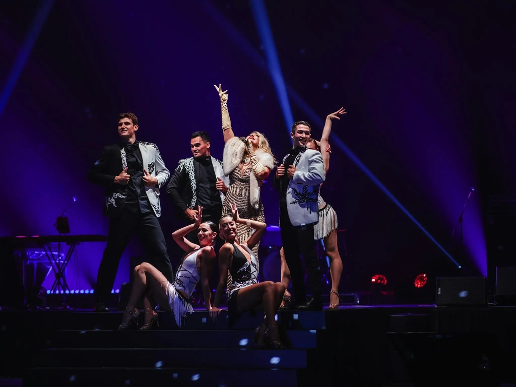 Dancers and a singer in Gatsby costumes pose