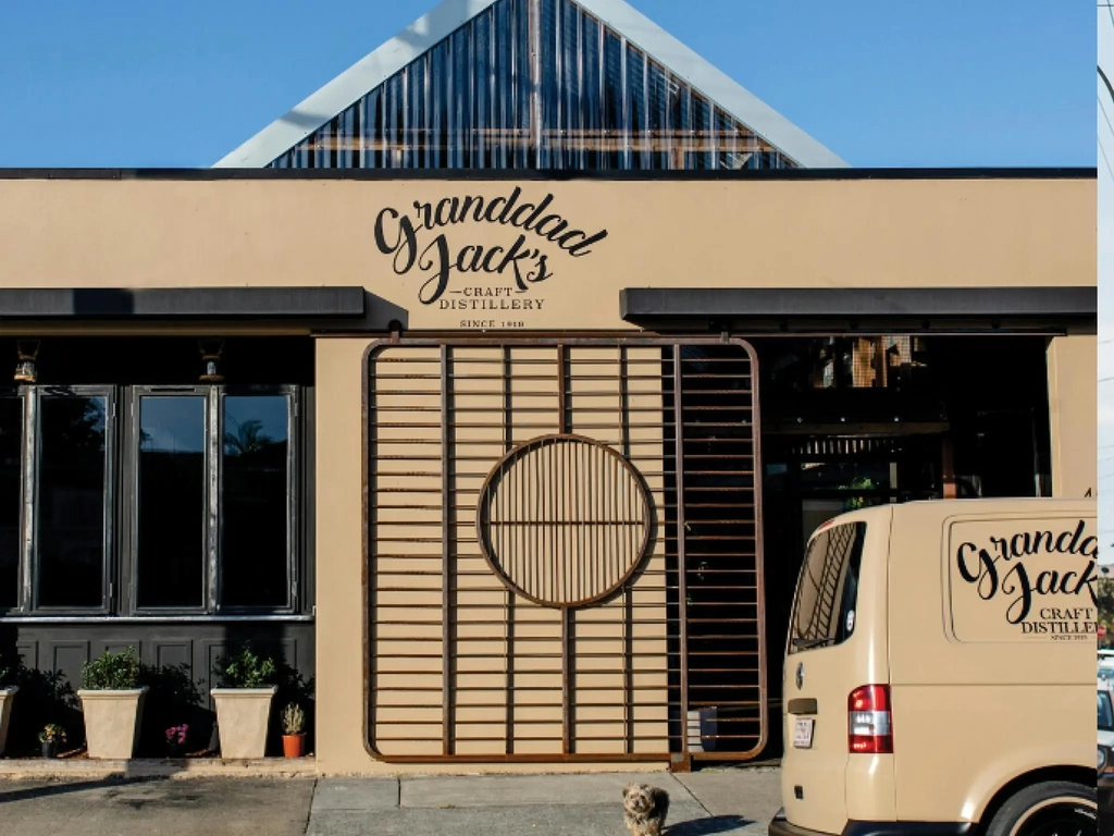 The tan building and van showcasing our Granddad Jack's Craft Distillery in Miami, Queensland.