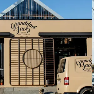 The tan building and van showcasing our Granddad Jack's Craft Distillery in Miami, Queensland.