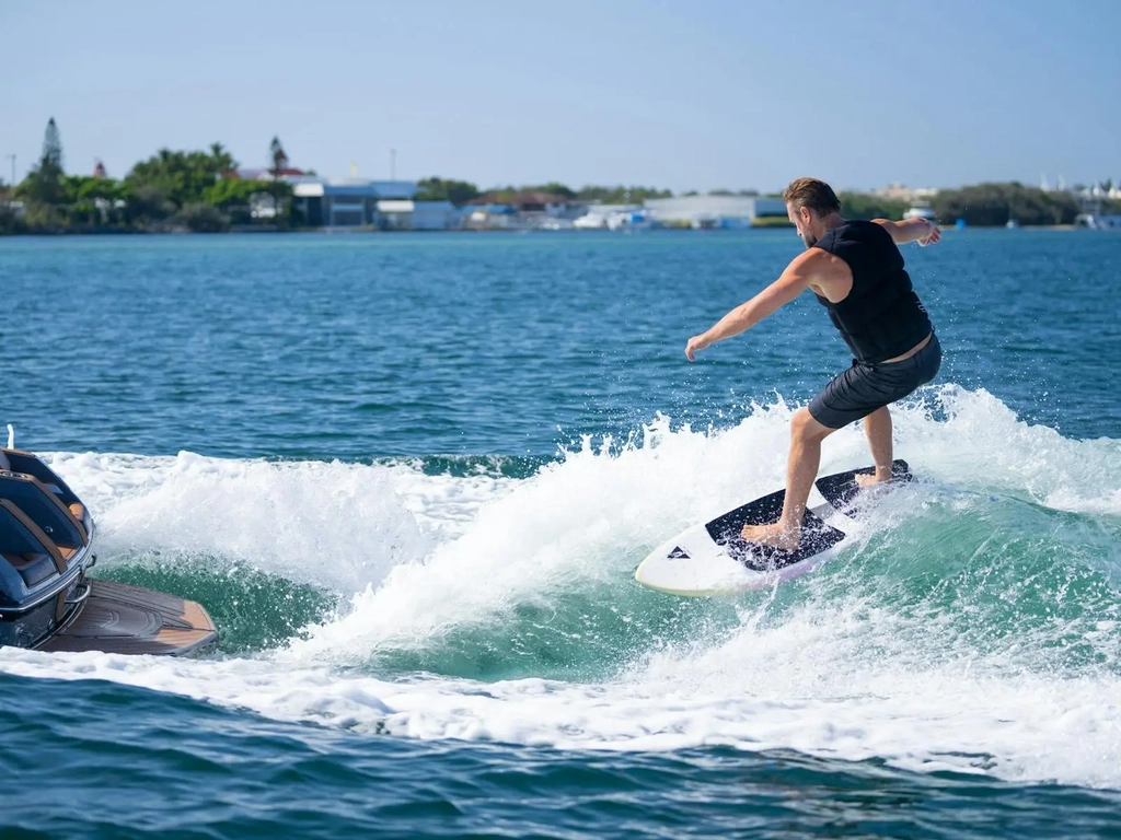 Crystal clear water with a wake surfer enjoying an awesome day behind the boat