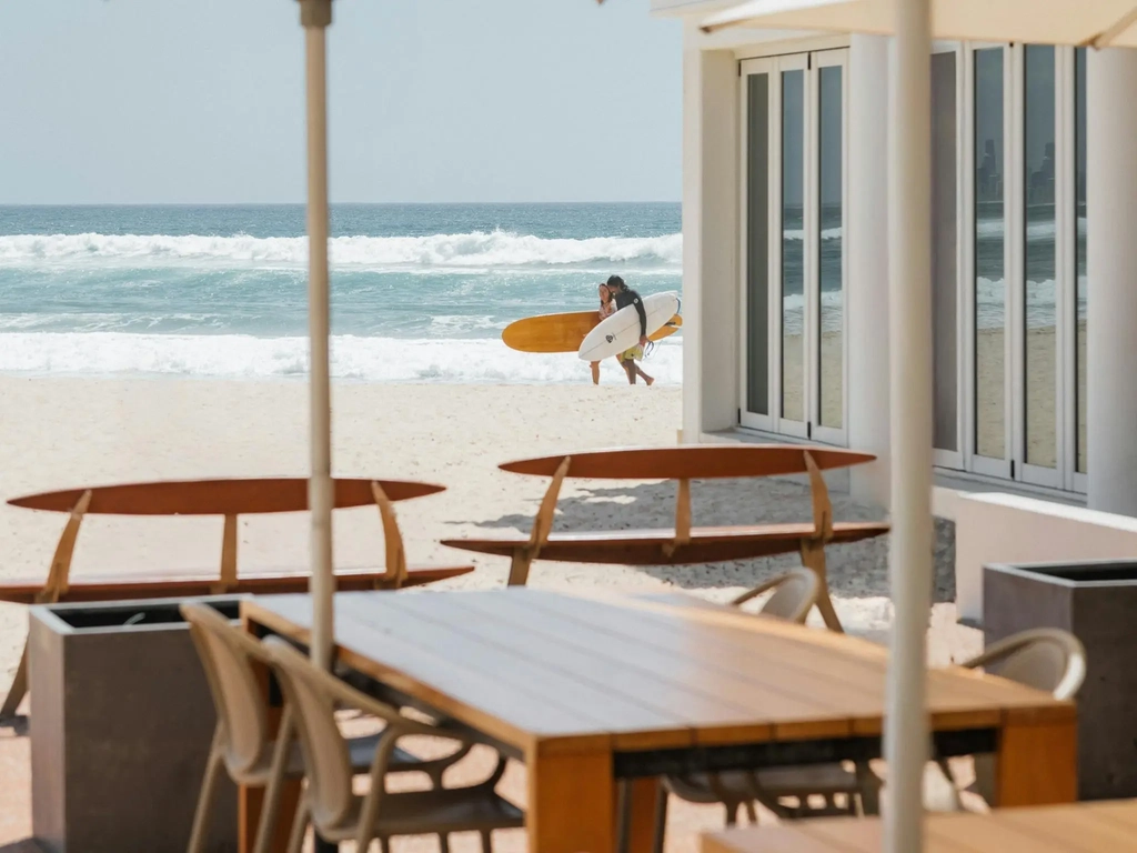 Rick Shore's Patio with surfers walking in the backgroup