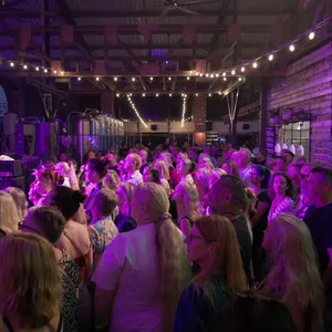 People inside of the venue standing enjoying a Daryl Braithwaite show