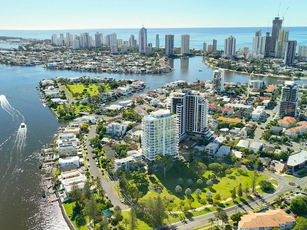 Aerial of the riverside residence with the Surfers Paradise skyline and coastline beyond