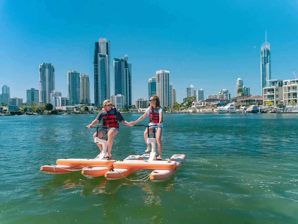 Couple holding hands on waterbike on the water