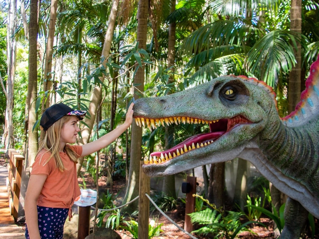 Young girl petting dinosaur