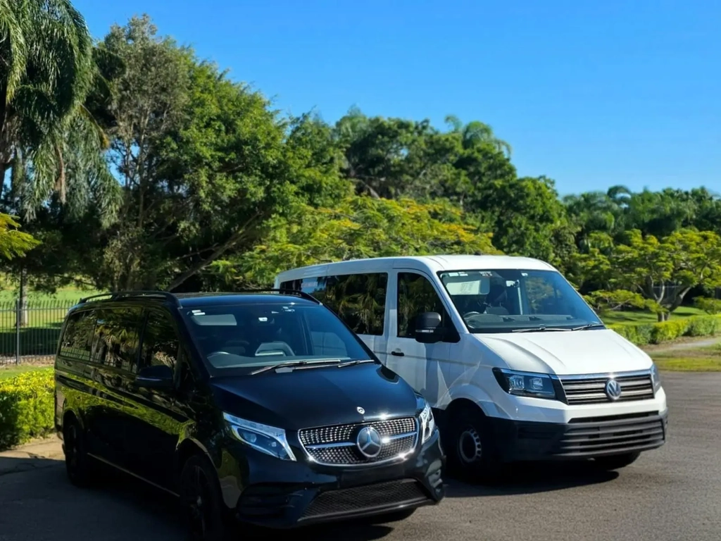Black Mercedes-Benz van and white Volkswagen van from GEC Transfers parked
