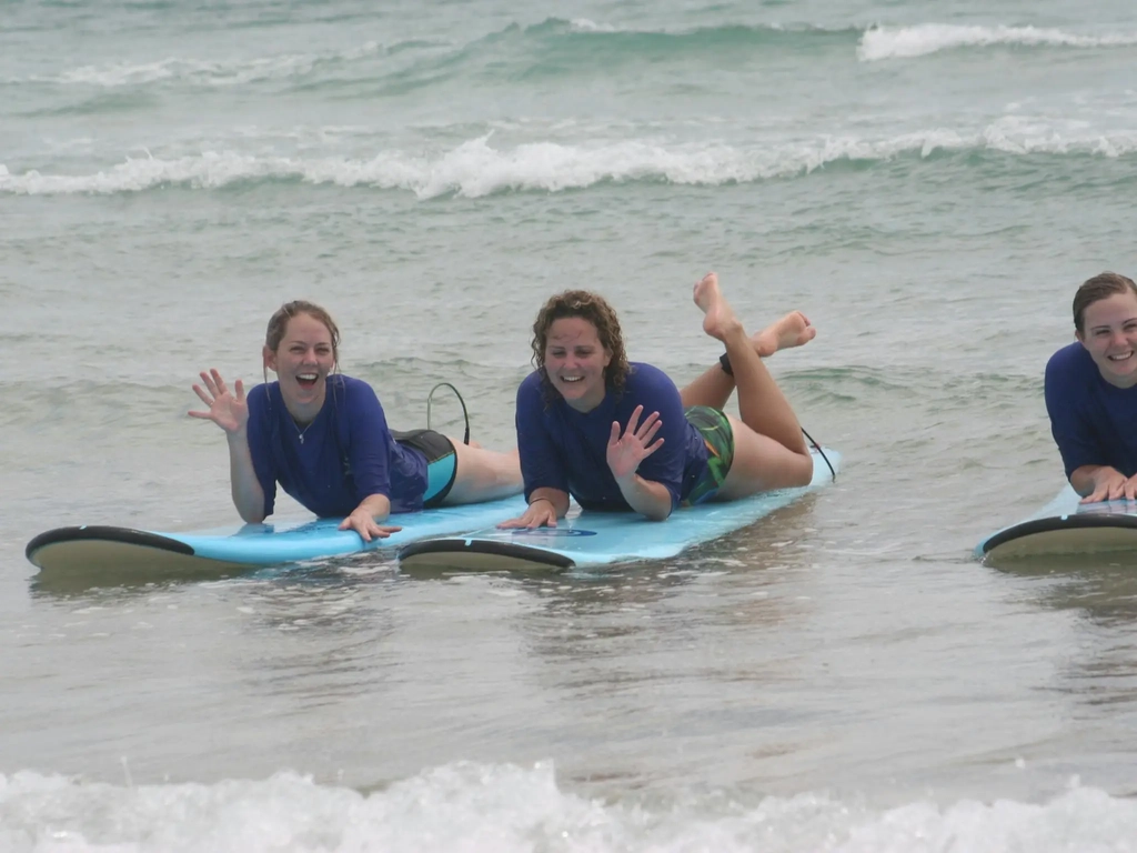 Two smiling surfers from Australian Surfing Adventures