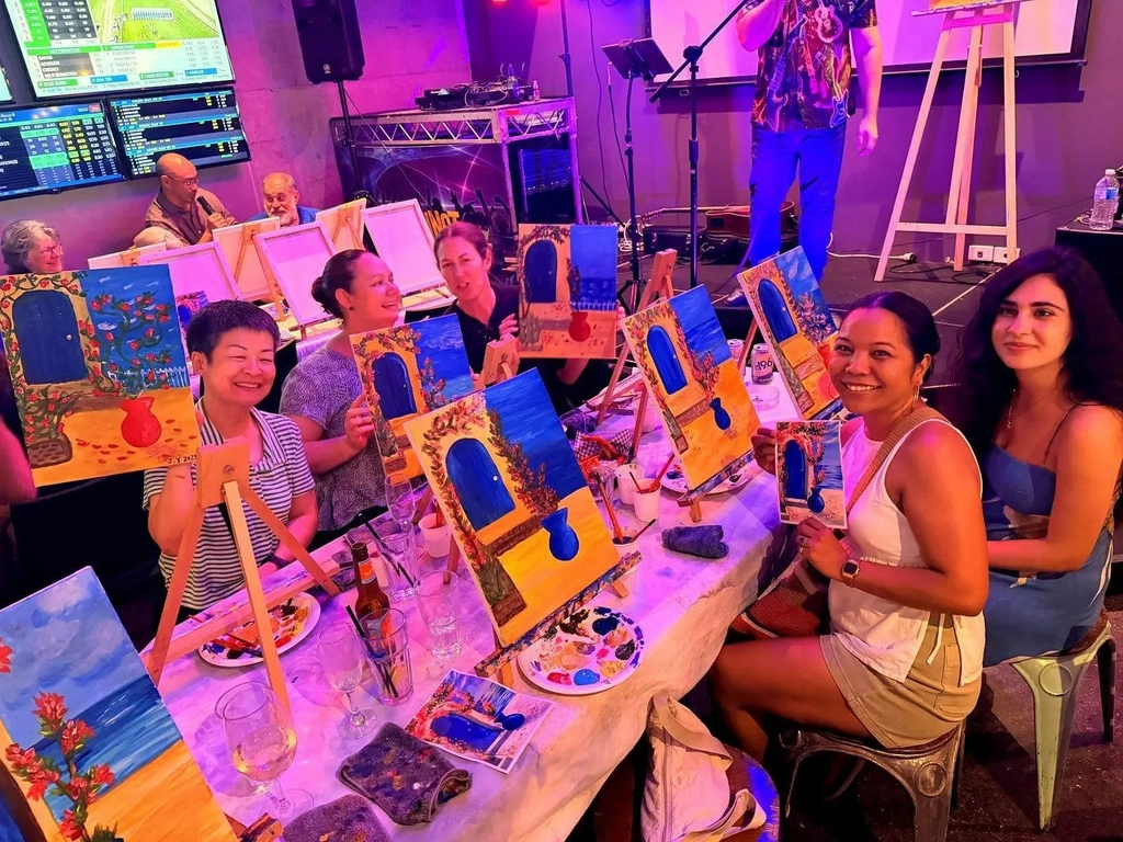 Paint Juicy host leading a full room at a mobile paint and sip event in Darwin