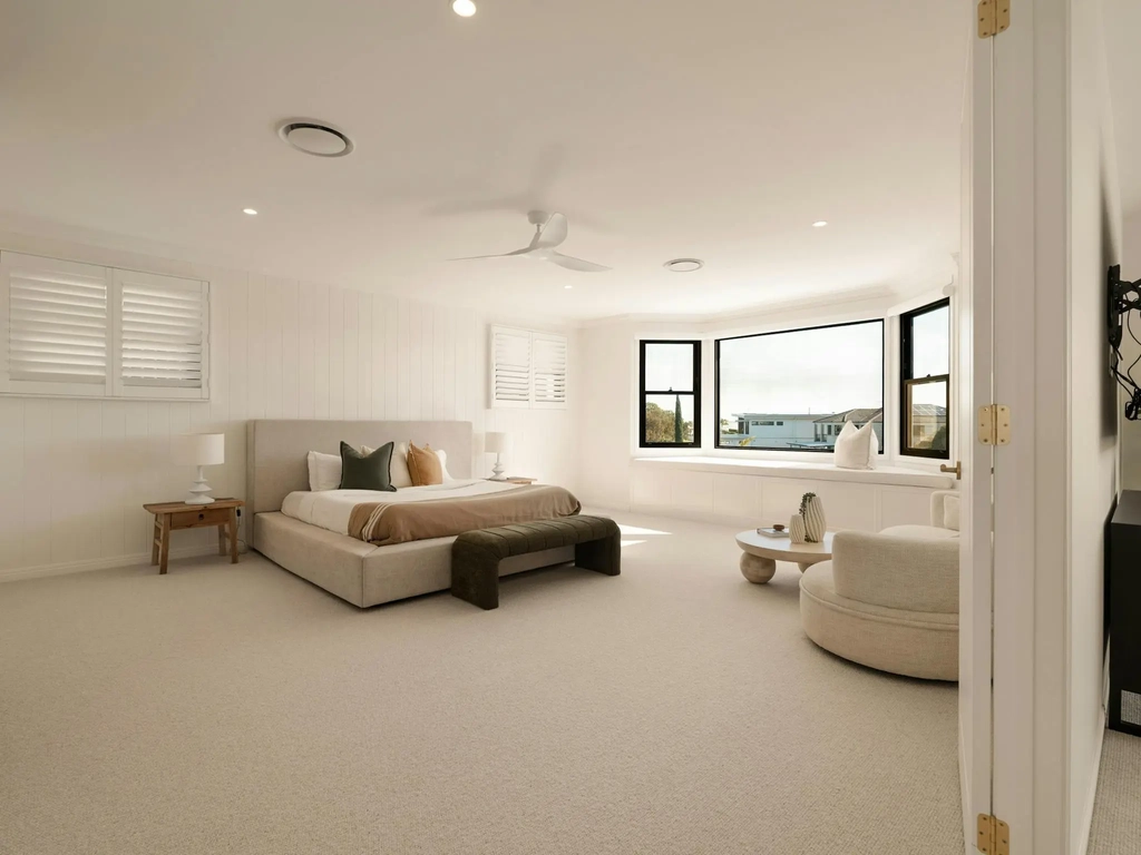 Main bedroom with a king bed, bay window and sitting area