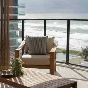 Terrace with timber screens and armchair looking over the beach and surf