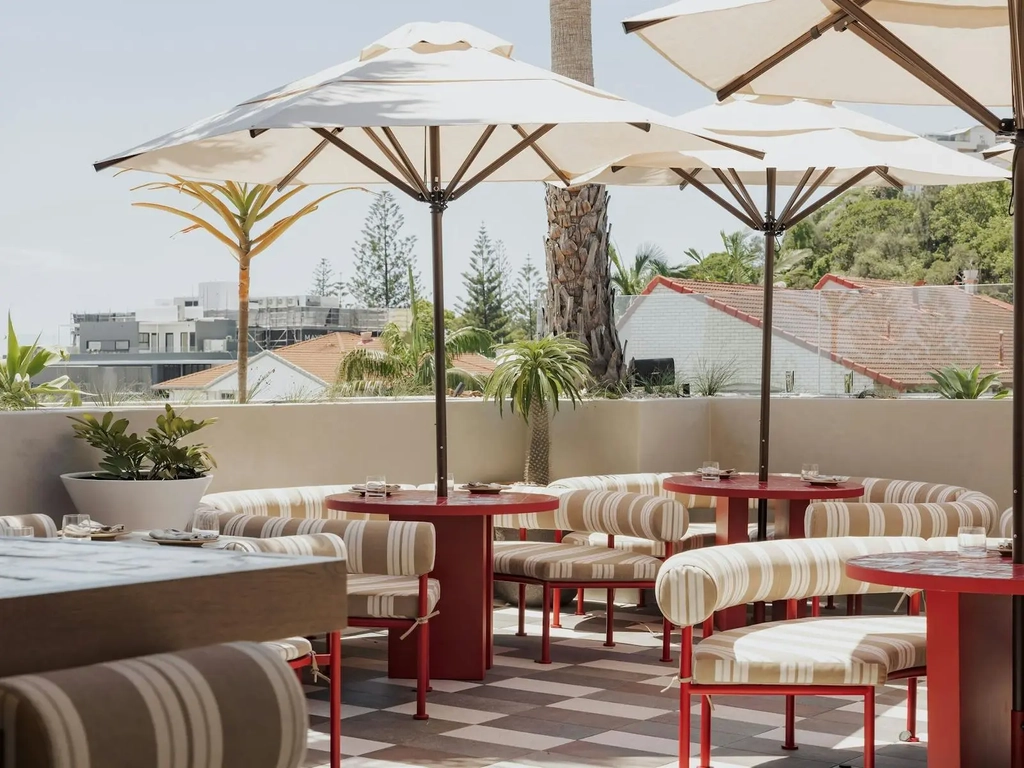 Sueno rooftop showing booths with open umbrellas