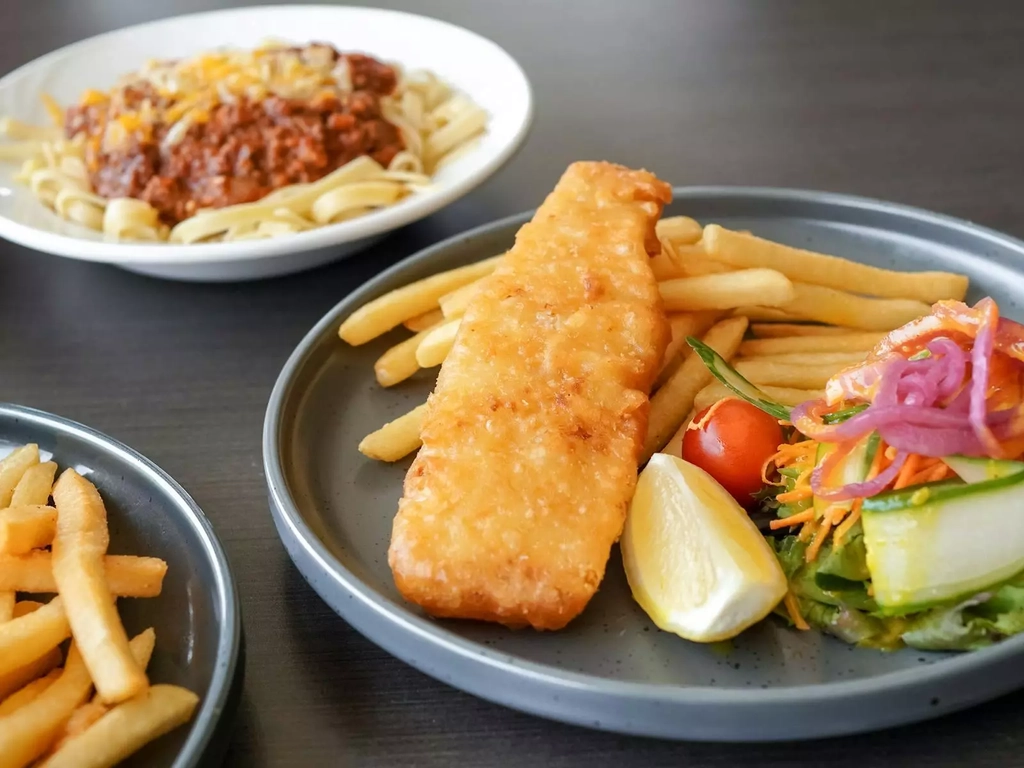 An image featuring fish & chips, and spaghetti bolognese
