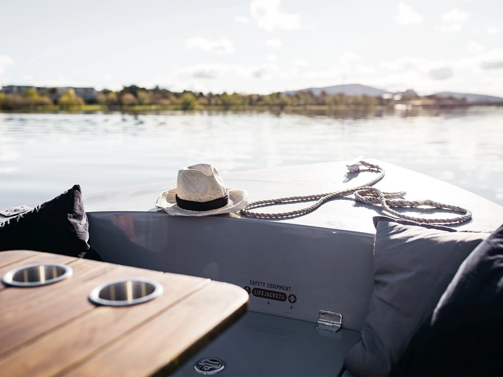 A GoBoat electric picnic boat sits on the water