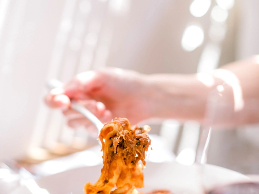 Bowl of pasta with glass of red wine