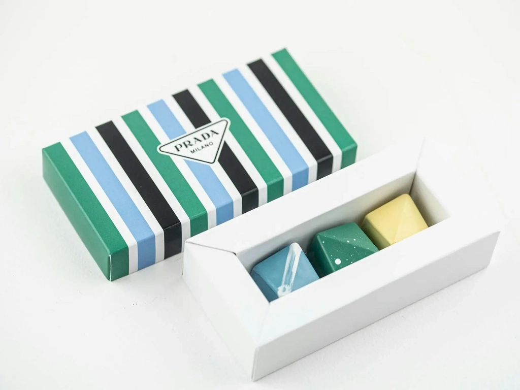 Box of Prada chocolates open with blue, green and yellow colours