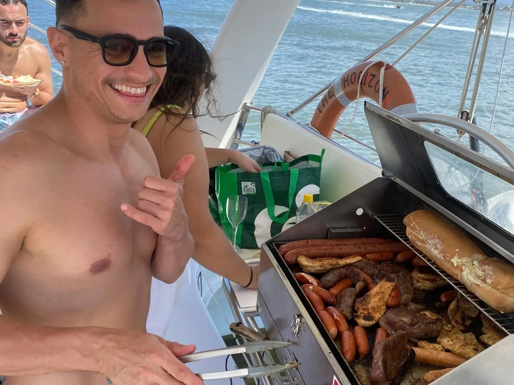 Passengers cooking a BYO BBQ on a private boat charter