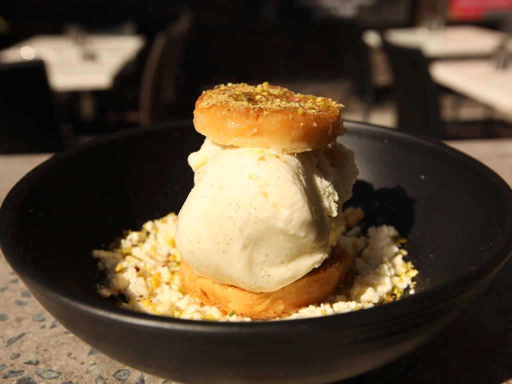 Baklava & vanilla bean ice cream sandwich served on soft white cheese drizzled with rosewater