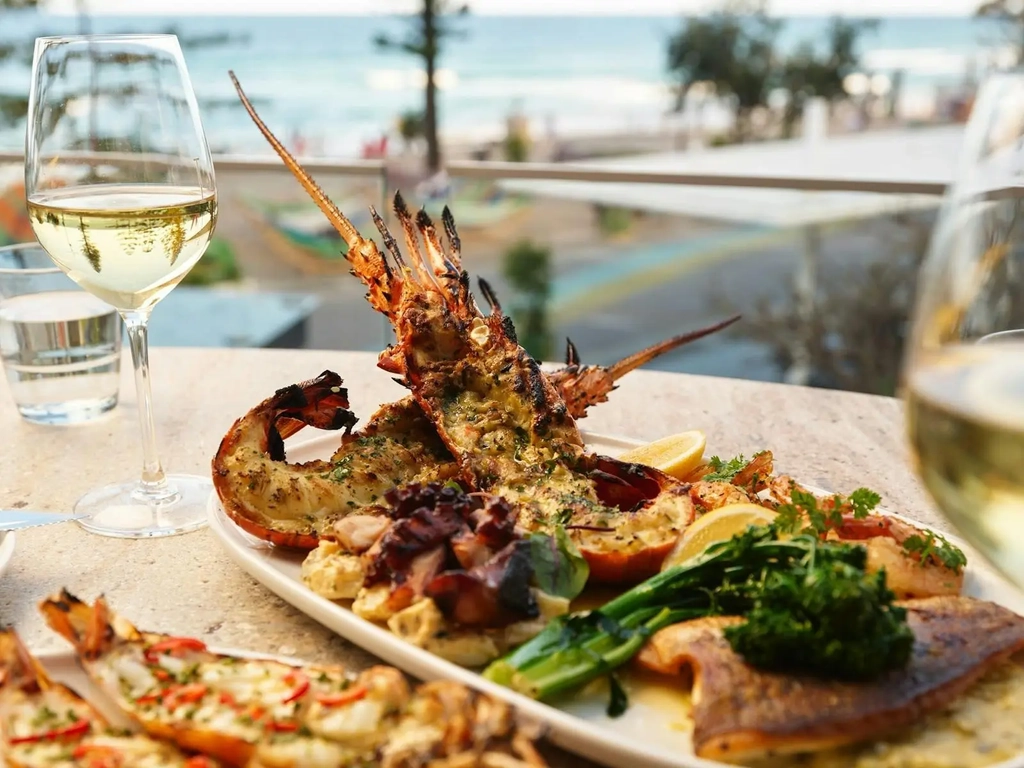 Hurricane's Surfers Paradise - Seafood Platter With A Glass of White Wine and a Beach View
