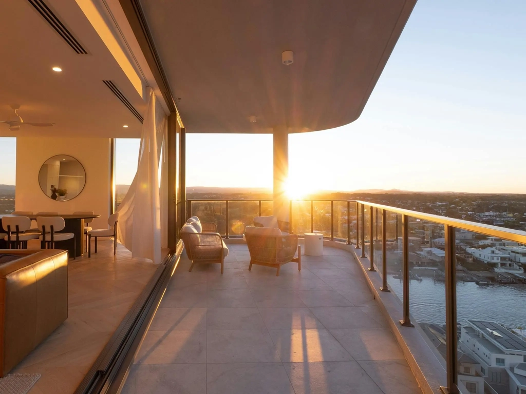 Curved terrace at sunset with lounge seating and river views