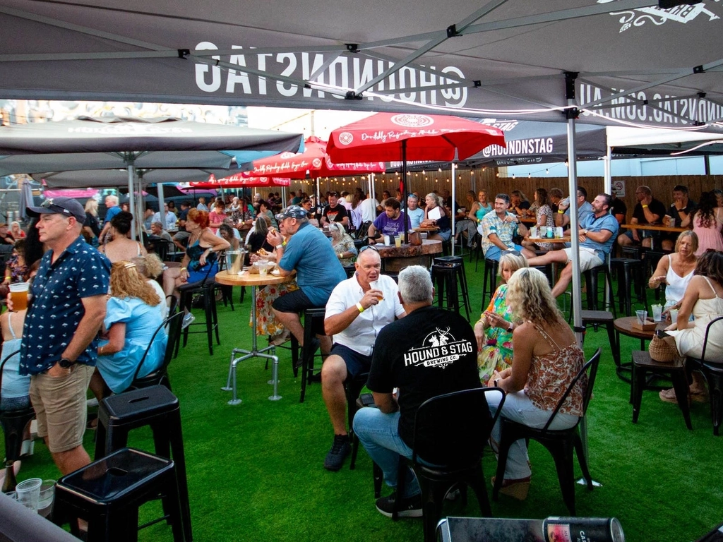 People outside the venue in the beer garden during the afternoon