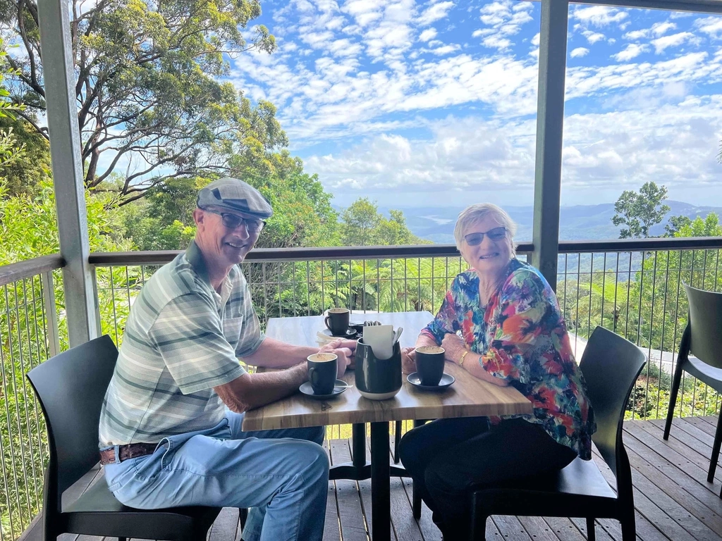 Image shows an couple enjoying a coffee overlooking the hinterland.