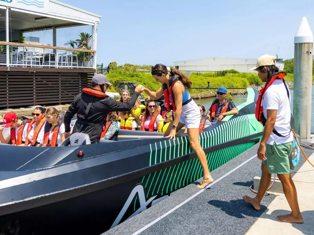 Jet Boat Driver assisting a guest to get into the Arro Jet Boat.