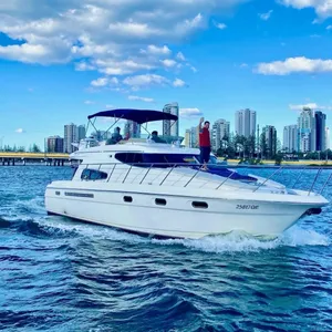 Luxury yacht on clear blue water with city skyline in the background – Broadwater, Gold Coast.