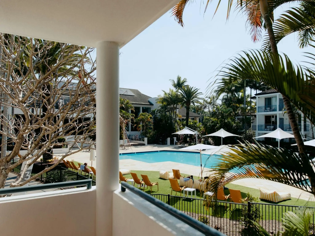 View from balcony of hotel room overlooking the pool
