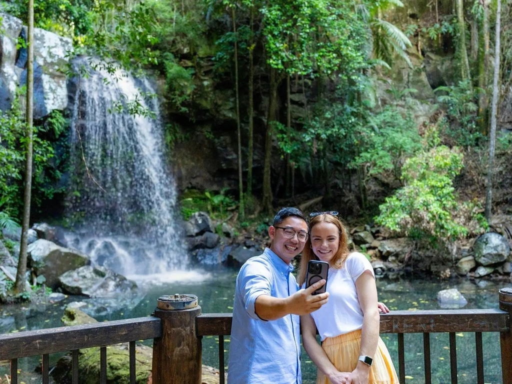 2 people taking a selfie in front of Curtis Falls