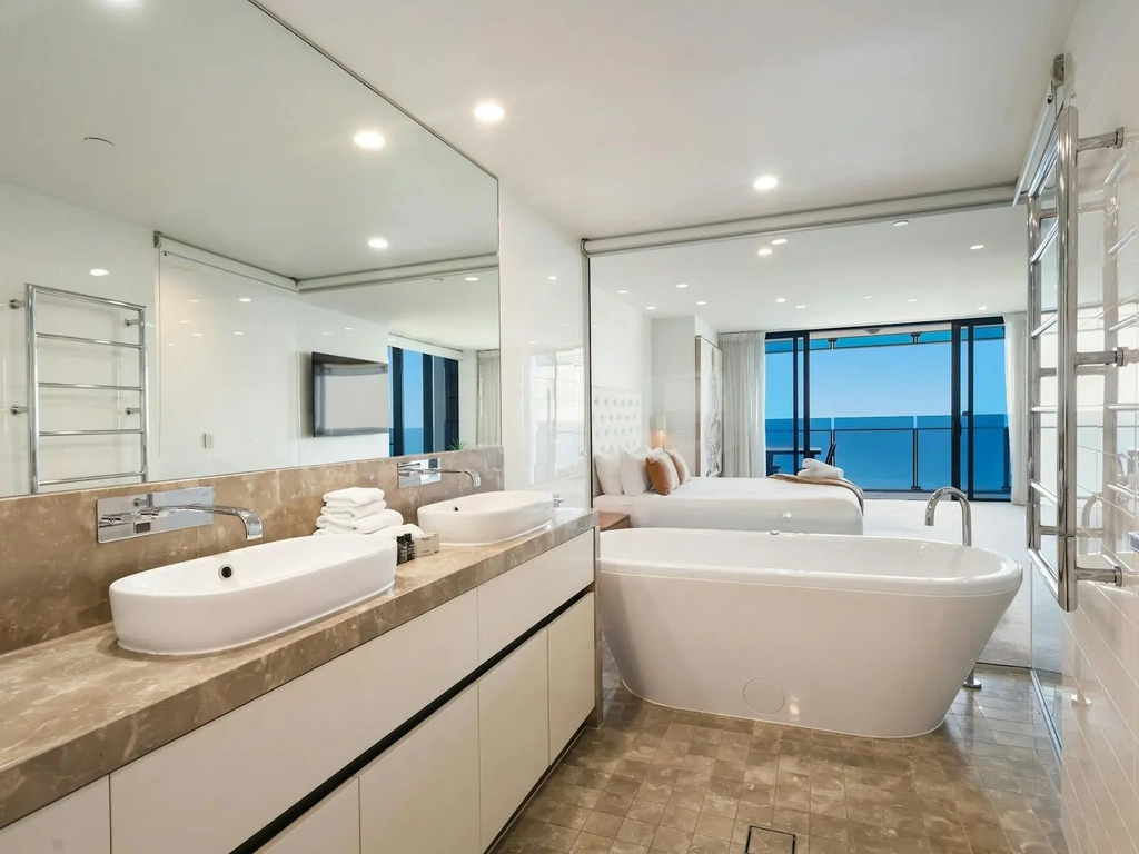 Main ensuite with bath tub,  and ocean views, his and her vanity