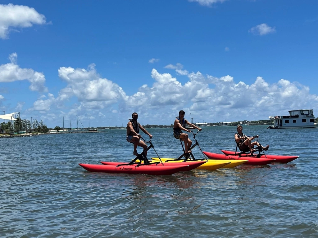 Group of young men enjoy waterbiking.