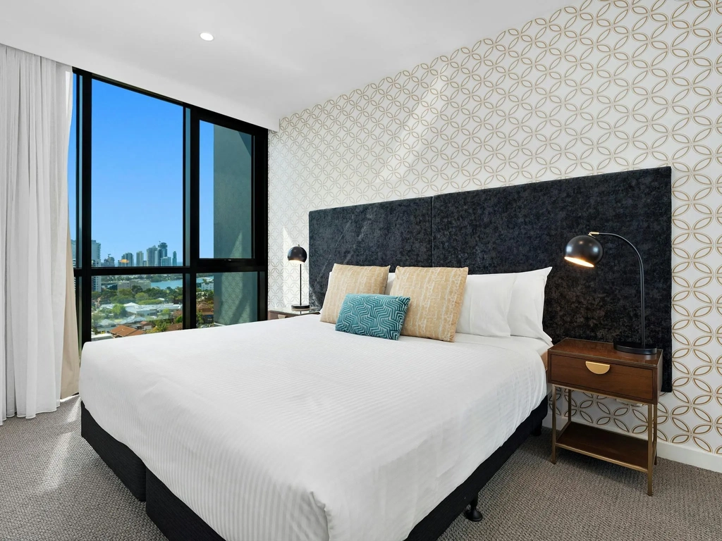 Spacious two-bedroom apartment with modern decor, private balcony, and stunning Gold Coast views.