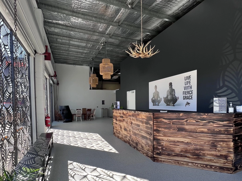 Reception with recycled wood desk, branding  poster and deer antler pendant light.