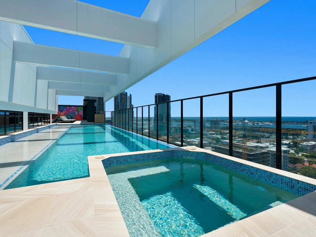 Rooftop infinity pool with panoramic views of the Gold Coast, perfect for relaxing or sunset swims.