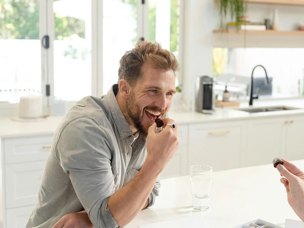 Man eating a chocolate praline