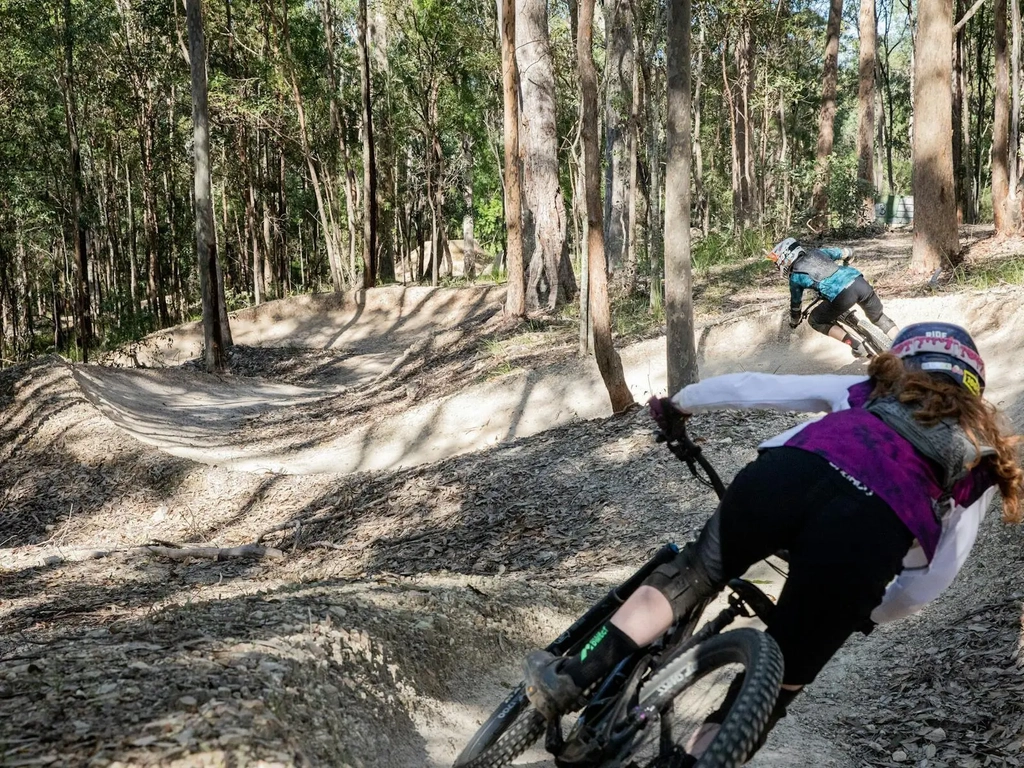 riders on berms at bike park