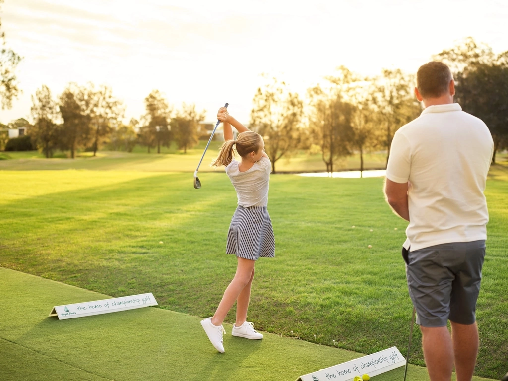 Father and daughter playing golf